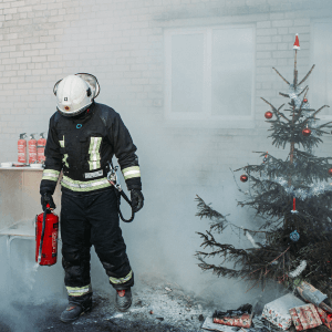 fire fighter in smoky room near christmas tree